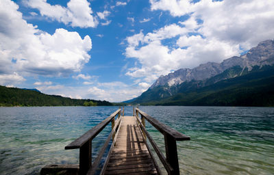 Pier over lake against sky