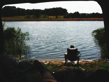 Rear view of people sitting in lake