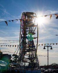 Low angle view of ferris wheel against sky