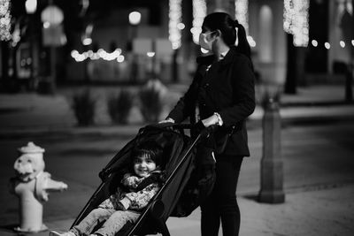 Side view of a mother standing on street