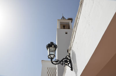 Low angle view of street light against building