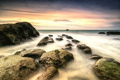 Scenic view of sea against sky at sunset