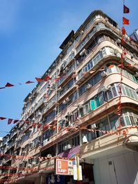 Low angle view of buildings against clear blue sky