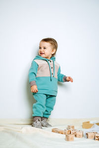 Baby fashion. unisex clothes for babies. cute baby in cotton set suit on light background.