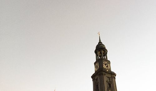 High section of church tower against sky