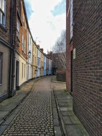 Empty alley amidst buildings in city