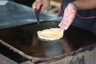 Midsection of man preparing food