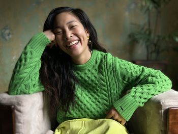 Portrait of young woman sitting on chair