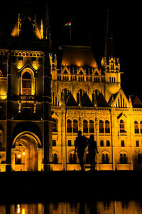 People in illuminated building at night