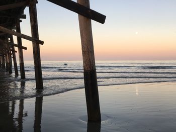 Scenic view of sea against clear sky at sunset