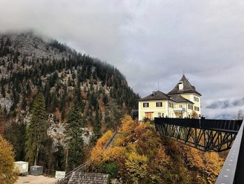 House on mountain against sky during autumn