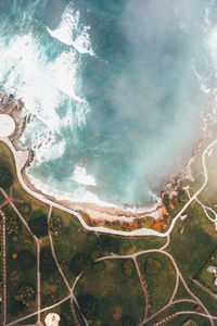 Deep blue sea, green coastline and white foam in northern spain