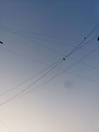 Low angle view of cables against sky at dusk