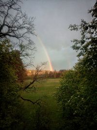 Scenic view of rainbow over landscape against sky