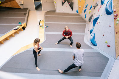 High angle view of coach training students at gym