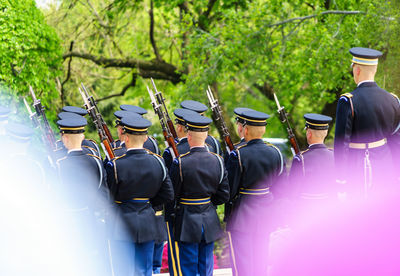 Rear view of armed forces against trees