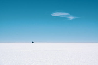 Scenic view of snowcapped landscape against blue sky