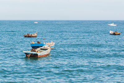 Sailboat in sea against clear sky