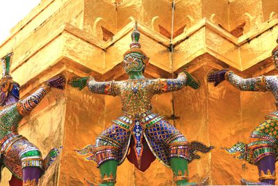 Low angle view of statue against temple building