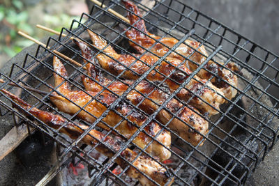 High angle view of meat on barbecue grill