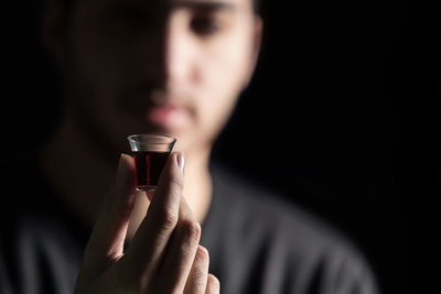 Close-up portrait of a man drinking glass