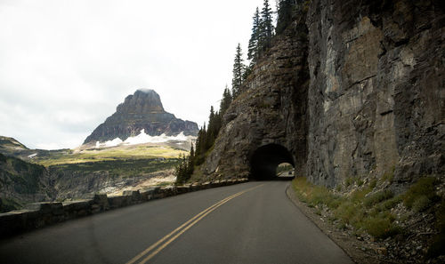 Road amidst mountains against sky