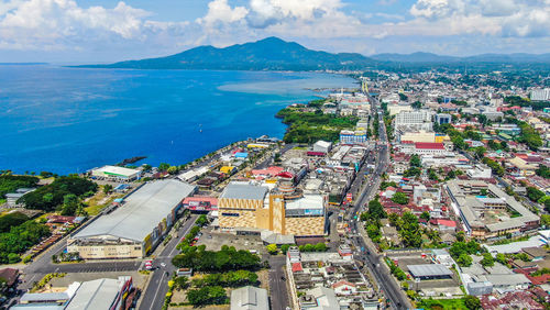 High angle view of buildings by sea against sky