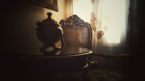 Close-up of electric lamp on table at home