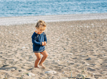 Full length of girl standing at beach