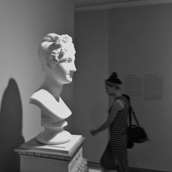 Young woman looking at statue