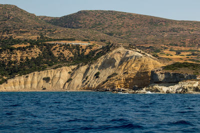 Scenic view of sea and mountains against sky