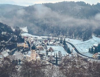 High angle view of townscape and trees during winter