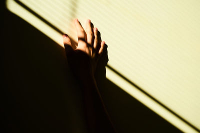 Close-up of hand on wall