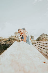 Low angle view of woman standing against sky