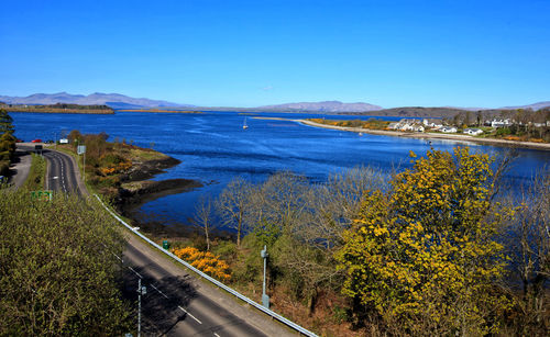 Scenic view of loch etive against clear blue sky