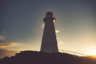 Low angle view of lighthouse against sky at night