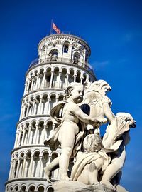 Low angle view of statue against blue sky