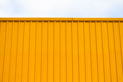 Low angle view of yellow wall against clear sky