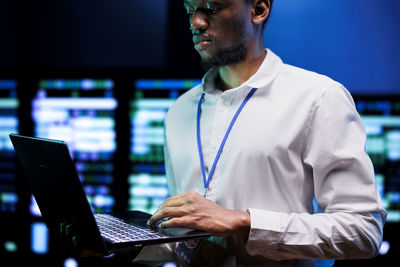 Portrait of businessman using laptop