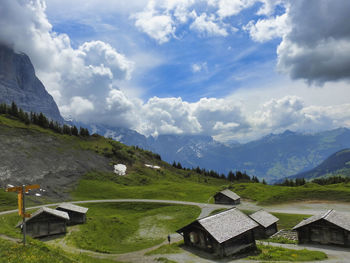 Scenic view of house and mountains against sky