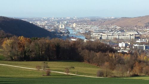 Aerial view of landscape with buildings in background