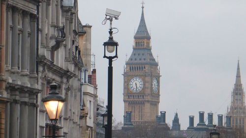 Clock tower in city against sky