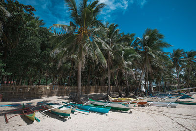 Boats moored on beach against sky