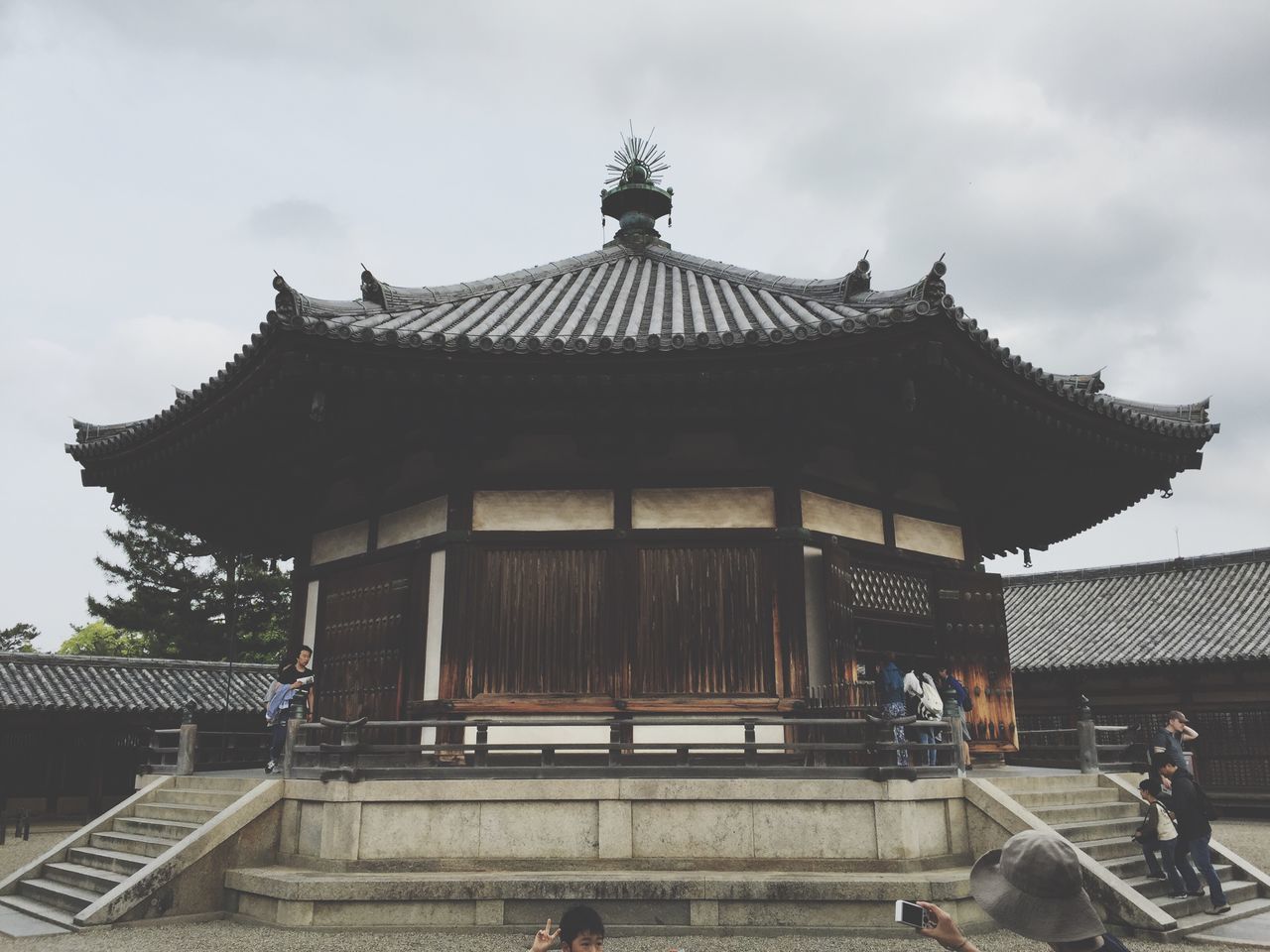 architecture, building exterior, built structure, place of worship, sky, religion, spirituality, low angle view, temple - building, facade, roof, cloud - sky, steps, history, exterior, entrance, outdoors, travel destinations, cloud