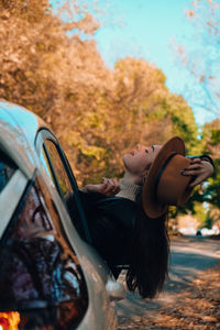 Side view of woman in car