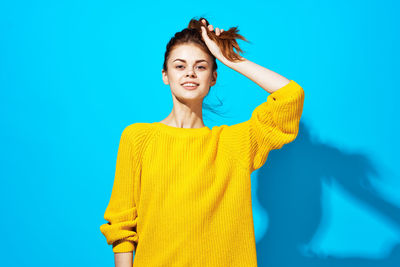 Woman standing against blue background
