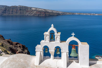 Typical church in oia overlooking the mediterranean sea, santorini, greece