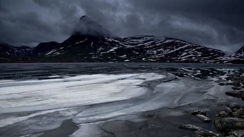 Scenic view of snowcapped mountains against sky during winter