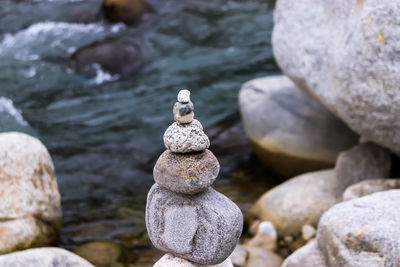 Stack of stones on rock at beach