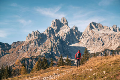 Man standing on mountain against sky